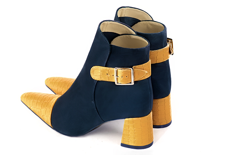 Mustard yellow and navy blue women's ankle boots with buckles at the back. Tapered toe. Medium flare heels. Rear view - Florence KOOIJMAN